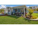 Quaint coastal home offering a manicured lawn, lovely front landscaping, and a cozy screened porch at 237 85Th St, Holmes Beach, FL 34217