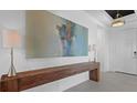 Inviting entryway showcasing a wood console table and modern artwork at 2578 Wild Cherry Path, Sarasota, FL 34240