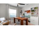 Bright home office featuring built in bookcases, neutral walls, and a large window at 2578 Wild Cherry Path, Sarasota, FL 34240