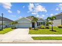 Charming single-story home with a two-car garage, manicured lawn, and lush landscaping at 2721 Greenleaf Ter, Parrish, FL 34219