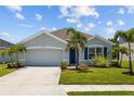 Charming single-story home featuring a two-car garage, well-manicured lawn and tropical landscaping at 2721 Greenleaf Ter, Parrish, FL 34219