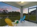 Screened-in patio with views of the pond, backyard, and comfortable seating at 2721 Greenleaf Ter, Parrish, FL 34219