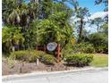 Pine Ranch East sign with palm trees and landscaping at 296 Pine Ranch Trl, Osprey, FL 34229