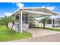Welcoming home with a convenient carport, grill, and vibrant landscaping for a pleasing outdoor space at 3333 26Th E Ave # 1104, Bradenton, FL 34208