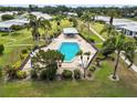Aerial view of a community pool with lounge chairs and a gazebo at 3649 Somerville Dr # 1507, Sarasota, FL 34232
