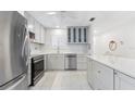 Updated kitchen with stainless steel appliances, gray cabinets, and white subway tile backsplash at 3978 Overlook Bend Ter # 25, Sarasota, FL 34232