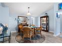 Cozy dining area featuring wood-look flooring, a glass table, and blue wall accents at 4203 Carriage Dr # 27, Sarasota, FL 34241