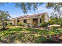 Beautiful single-story home features lush landscaping, healthy green grass, and a well-maintained exterior at 4203 Carriage Dr # 27, Sarasota, FL 34241