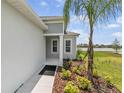 A welcoming entrance with a covered porch and a view of the lush landscaping at 4406 Rustling Pines Ter, Parrish, FL 34219