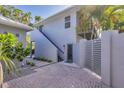 An exterior shot showing the back of the home with private courtyard and stairs to an apartment at 4505 Camino Real, Sarasota, FL 34231