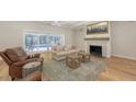 Cozy living room with a fireplace, hardwood floors, and sliding doors to the backyard at 4665 Pine Harrier Dr, Sarasota, FL 34231