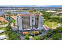 A high-rise building overlooking a beautiful bay with lush greenery and clear blue skies at 501 Haben Blvd # 506, Palmetto, FL 34221