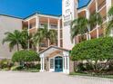 Beautiful condo entrance showcasing manicured bushes and palm trees at 5420 Eagles Point Cir # 106, Sarasota, FL 34231