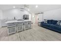 Open-concept kitchen features a spacious island with quartz countertops and bar stool seating at 55 Braden Castle Dr, Bradenton, FL 34208