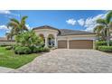 Charming home with meticulously maintained landscaping, a tile roof, and a brick-paved driveway at 5622 Arnie Loop, Lakewood Ranch, FL 34211