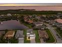 Stunning aerial shot of the property with lake view, surrounded by manicured lawns and beautiful landscaping at 5718 Title Row Dr, Bradenton, FL 34210