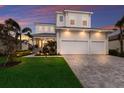 Beautiful two-story home with a three-car garage, lush lawn, and professionally landscaped front yard at 5718 Title Row Dr, Bradenton, FL 34210