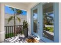 Welcoming front porch featuring a stylish blue door and views of the landscaped front yard at 5718 Title Row Dr, Bradenton, FL 34210