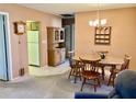 Inviting dining room area with wooden furniture, chandelier lighting, and views into the kitchen at 6110 Coral Way, Bradenton, FL 34207
