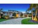 Beautiful exterior of a home with manicured landscaping and a circular driveway at 612 Mourning Dove Dr, Sarasota, FL 34236