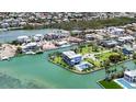 Waterfront property featuring lush greenery and private pool at 630 De Narvaez Dr, Longboat Key, FL 34228
