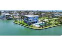 Exterior view of home on the water featuring a pool, grassy yard and balconies at 630 De Narvaez Dr, Longboat Key, FL 34228