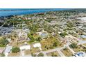 Aerial shot of a residential neighborhood with a view of the coastline and ocean in the distance at 645 Liberty St, Englewood, FL 34223