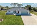Charming single-story home with attached garage, manicured lawn and updated roof at 645 Liberty St, Englewood, FL 34223