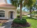 Inviting home exterior featuring a well-manicured lawn, palm trees, and community pool access at 7273 Cedar Hollow Cir # 102, Bradenton, FL 34203