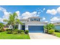 Inviting two-story home with well-kept lawn, lush greenery, and a convenient two-car garage at 7379 47Th Avenue E Cir, Bradenton, FL 34203