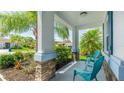 Cozy covered porch with seating area, perfect for enjoying the beautifully landscaped front yard at 7379 47Th Avenue E Cir, Bradenton, FL 34203