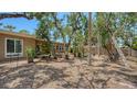 Large, shaded backyard with mature trees and lush tropical foliage creating a private oasis at 755 Edgemere Ln, Sarasota, FL 34242