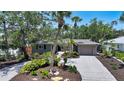 Charming home with a brick driveway and lush landscaping creates inviting curb appeal at 755 Edgemere Ln, Sarasota, FL 34242