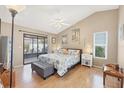 Serene main bedroom featuring a sliding glass door to the lanai, ceiling fan, and coordinating furniture at 7834 38Th E Ct, Sarasota, FL 34243