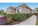 Charming single-story home with a well-manicured lawn and lush landscaping at 8706 52Nd E Dr, Bradenton, FL 34211