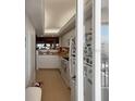 A bright kitchen with white cabinets and appliances, offering a glimpse of the ocean view at 8977 Midnight Pass Rd # 521, Sarasota, FL 34242