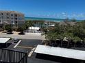 Scenic ocean view from a balcony with the beach visible in the distance at 8977 Midnight Pass Rd # 521, Sarasota, FL 34242