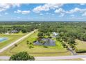 Expansive property featuring a serene pond with a fountain, lush greenery and privacy at 919 Palm View Way, Sarasota, FL 34240