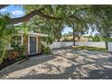 Inviting home exterior showcasing stone accents, lush landscaping, and white fence at 1019 S Tuttle Ave, Sarasota, FL 34237