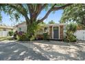Charming single-story home with lush landscaping and a welcoming front entrance at 1019 S Tuttle Ave, Sarasota, FL 34237