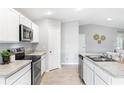 Clean kitchen with stainless appliances, white cabinets, and neutral countertops at 10539 Kidron Ave, Englewood, FL 34224