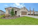 Beautiful single-Gathering home featuring a well-manicured lawn, neutral colored paint, and a two car garage at 11427 Viani Ter, Palmetto, FL 34221