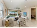 Bright living room with stylish furniture, neutral tones, tile flooring, and a lake view at 121 Porta Vecchio Bnd # 201, Nokomis, FL 34275