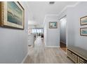 Inviting hallway with tile floors, neutral paint and views of the living spaces at 1255 E Peppertree Dr # 507, Sarasota, FL 34242