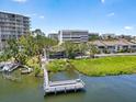 Scenic waterfront view featuring lush greenery and a private dock at 1255 E Peppertree Dr # 507, Sarasota, FL 34242
