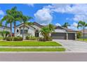 Charming home featuring a well-manicured lawn, stucco exterior, and a convenient three-car garage at 12644 20Th E St, Parrish, FL 34219