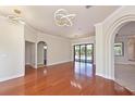 Elegant living room boasts hardwood floors, modern lighting, and seamless access to outdoor pool at 12644 20Th E St, Parrish, FL 34219