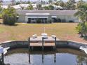 Canal-front home with boat dock, large backyard, and mature landscaping at 135 Gulfview Rd, Punta Gorda, FL 33950