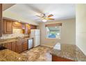 Traditional kitchen with wooden cabinets, granite countertops, and stainless steel appliances at 135 Gulfview Rd, Punta Gorda, FL 33950
