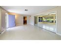 Spacious living room featuring neutral walls, large windows, and access to other areas at 135 Gulfview Rd, Punta Gorda, FL 33950